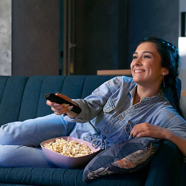 woman watching tv with popcorn